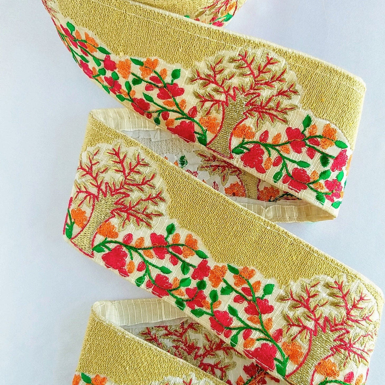 Beige Fabric Trim With Intricate Floral And Trees Embroidery In Gold, Red, Green And Orange Thread