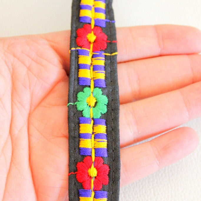 Black Fabric Trim With Green, Blue, Red And Orange Embroidery