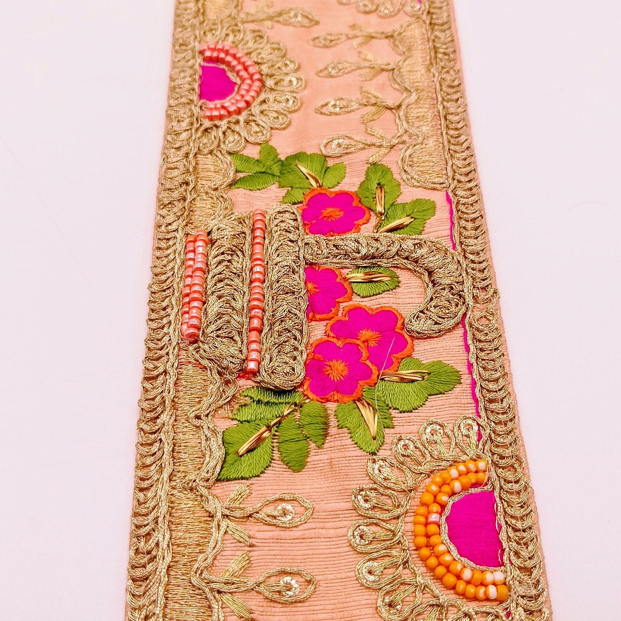 Peach Art Silk Fabric Trim With Green, Orange, Fuchsia Pink And Gold Floral Embroidery