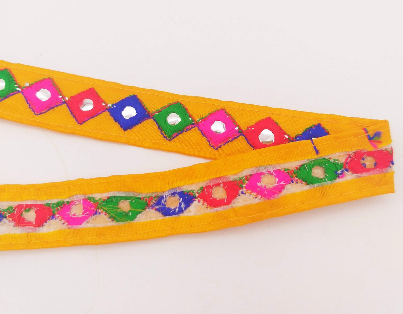 Wholesale Yellow Cotton Fabric Mirrored Trim With Embroidery In Fuchsia Pink, Blue, Red & Green Threads