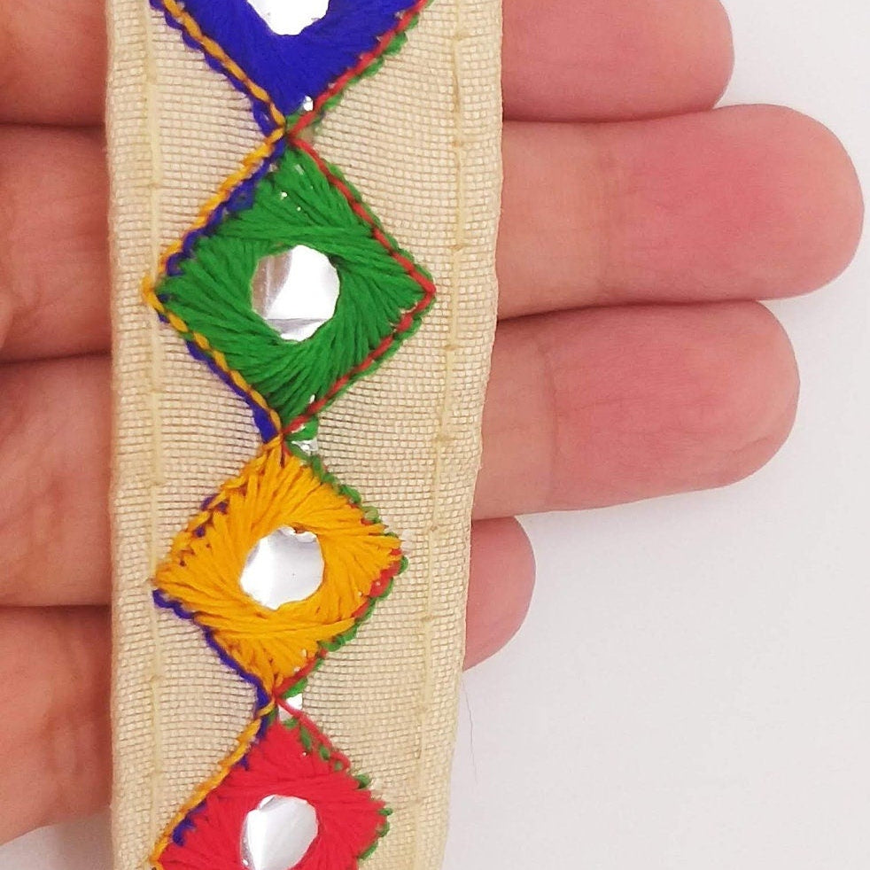Wholesale Beige Cotton Fabric Mirrored Trim With Embroidery In Yellow, Blue, Red & Green Threads