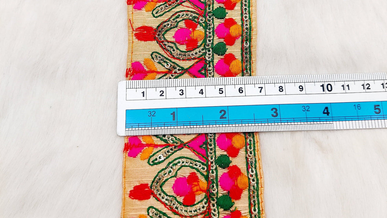 Peach Fabric Trim With Green, Fuchsia Pink, Red And Orange Embroidery and Gold Sequins