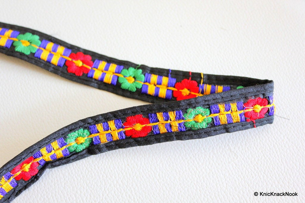 Black Fabric Trim With Green, Blue, Red And Orange Embroidery